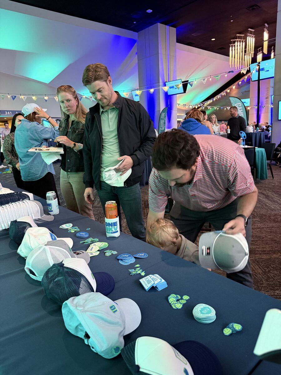 Corporate event merch table stacked with custom apparel and gift items