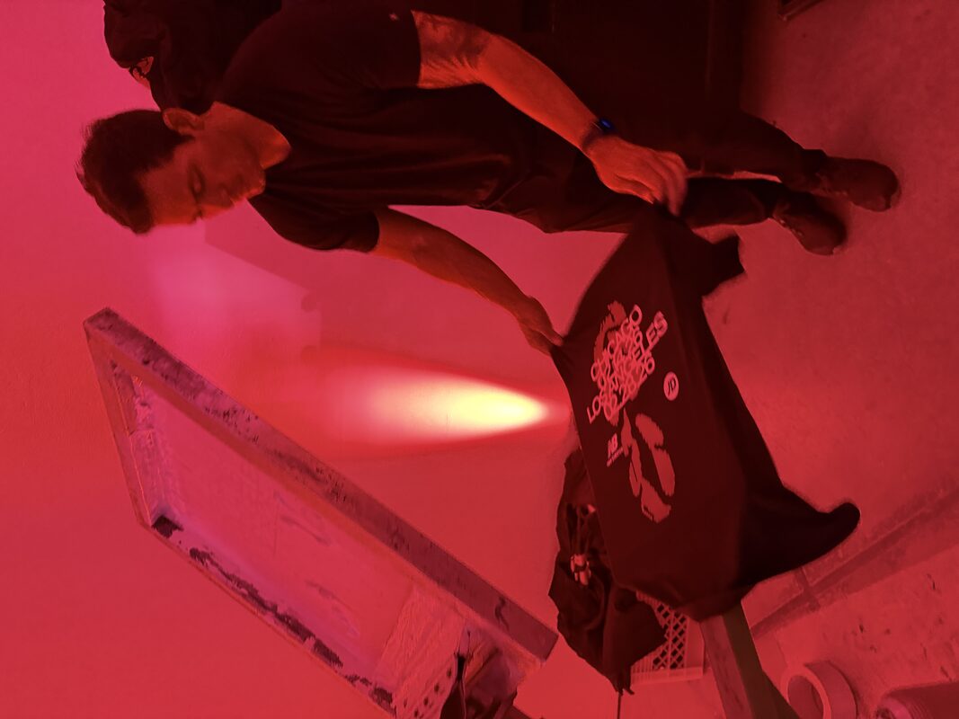 Wide view of a crowded indoor event space during a live activation