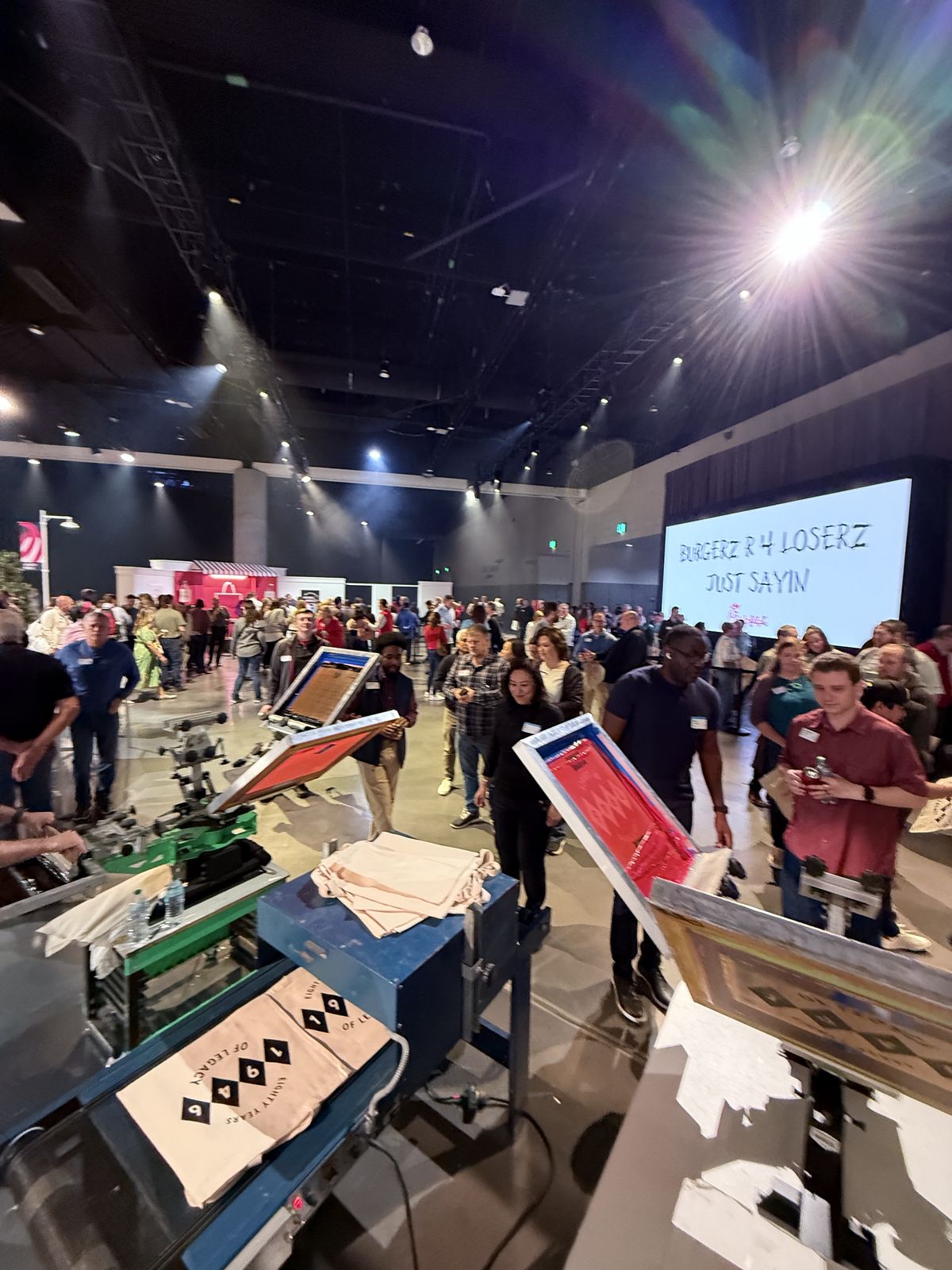 Live printing station serving a large crowd inside a ballroom venue
