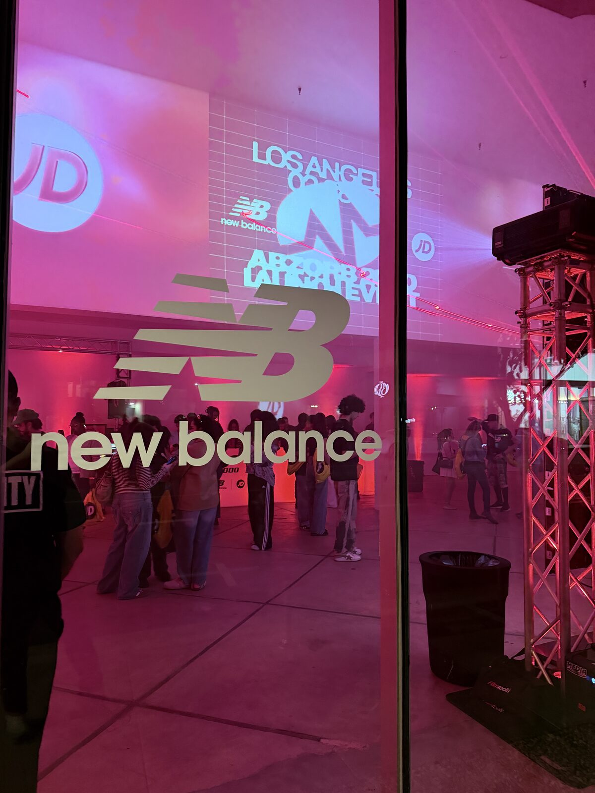 Crowd gathered outside a retail store window during a product launch event